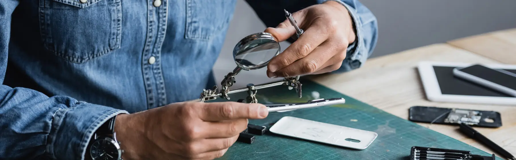 scotia-phone-repair-bench Technician repairing a mobile phone at a workbench