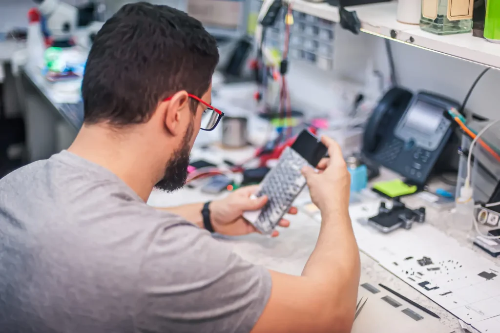 scotia-repair-workshop Phone repair technician at a workbench