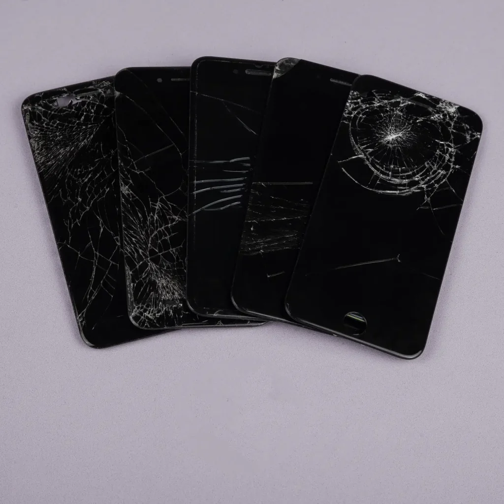 Several phones with cracked screens